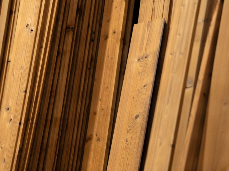 Stacks of reclaimed wood and reused building materials at Buurman Utrecht | Waste Alchemists