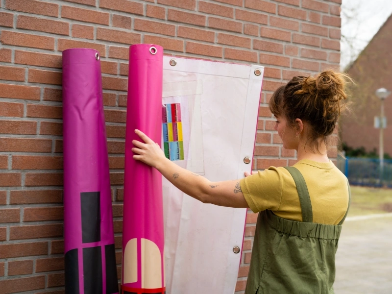 Stack of large discarded festival banners collected by Studio Fiep | Waste Alchemists