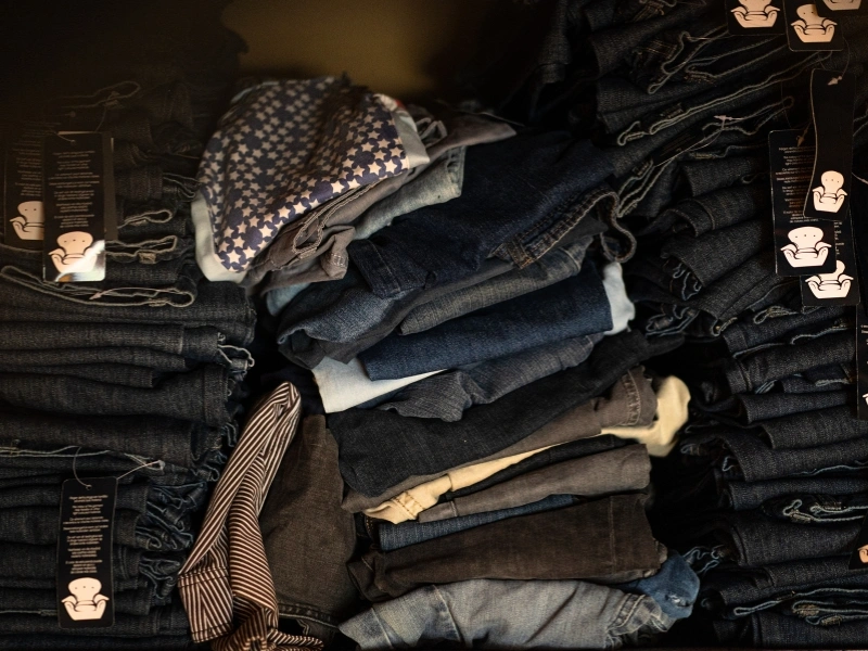 Piles of denim waste rescued by Outfits | Waste Alchemists