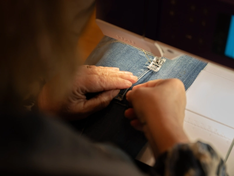 Denim waste being sewn into new products by Outfits | Waste Alchemists